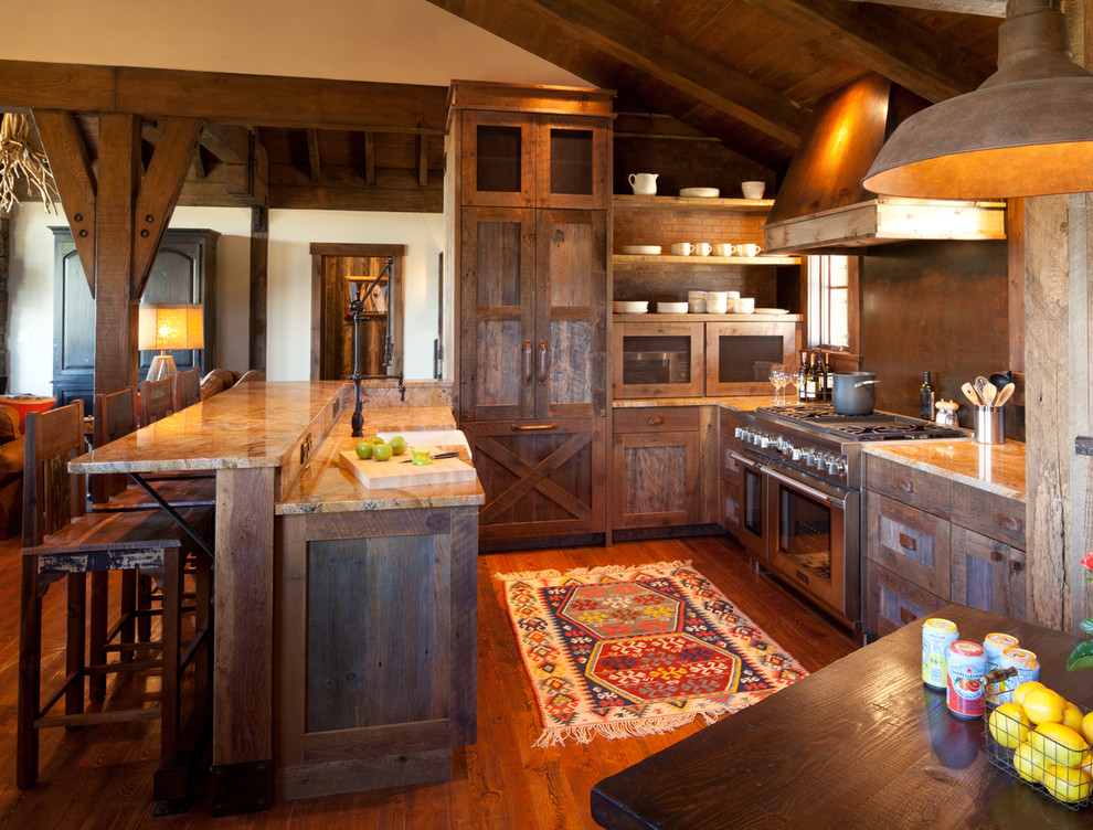 Inspiration for a country u-shaped eat-in kitchen in Denver with a farmhouse sink, flat-panel cabinets, distressed cabinets, granite benchtops, brown splashback, metal splashback and panelled appliances.