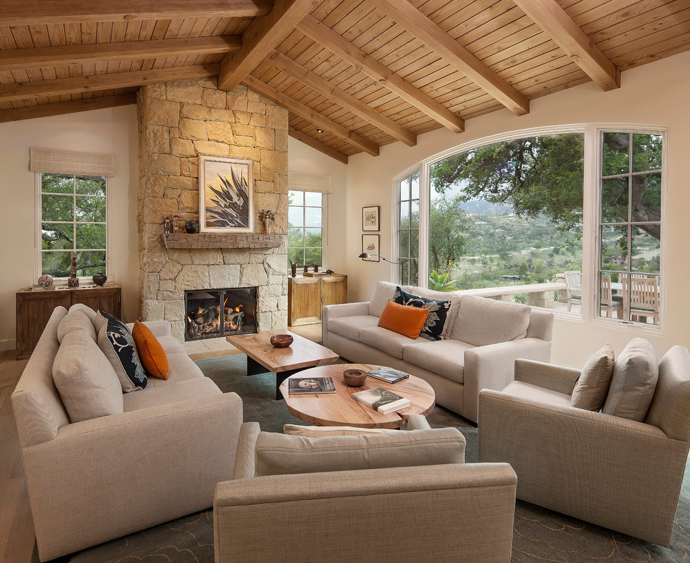 Inspiration for a mediterranean living room remodel in Santa Barbara with beige walls, a standard fireplace and no tv