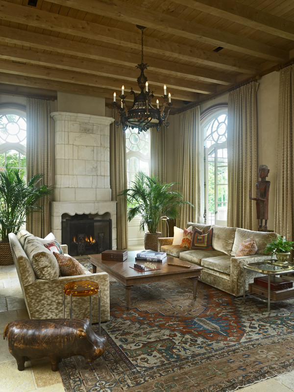 Example of a huge tuscan open concept travertine floor family room library design in Chicago with beige walls, a standard fireplace and a stone fireplace