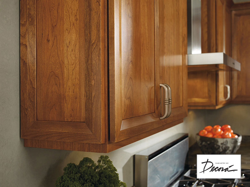 Eat-in kitchen - small l-shaped eat-in kitchen idea with medium tone wood cabinets, stainless steel appliances, a peninsula and gray countertops
