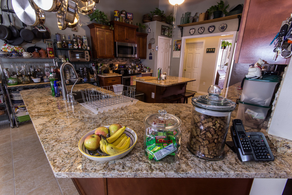 Example of a mid-sized galley cement tile floor and beige floor eat-in kitchen design with an undermount sink, shaker cabinets, medium tone wood cabinets, granite countertops, multicolored backsplash, glass sheet backsplash, stainless steel appliances, an island and beige countertops