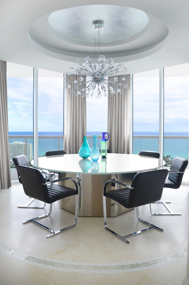 This is an example of a contemporary open plan dining in Miami with limestone floors and beige floor.