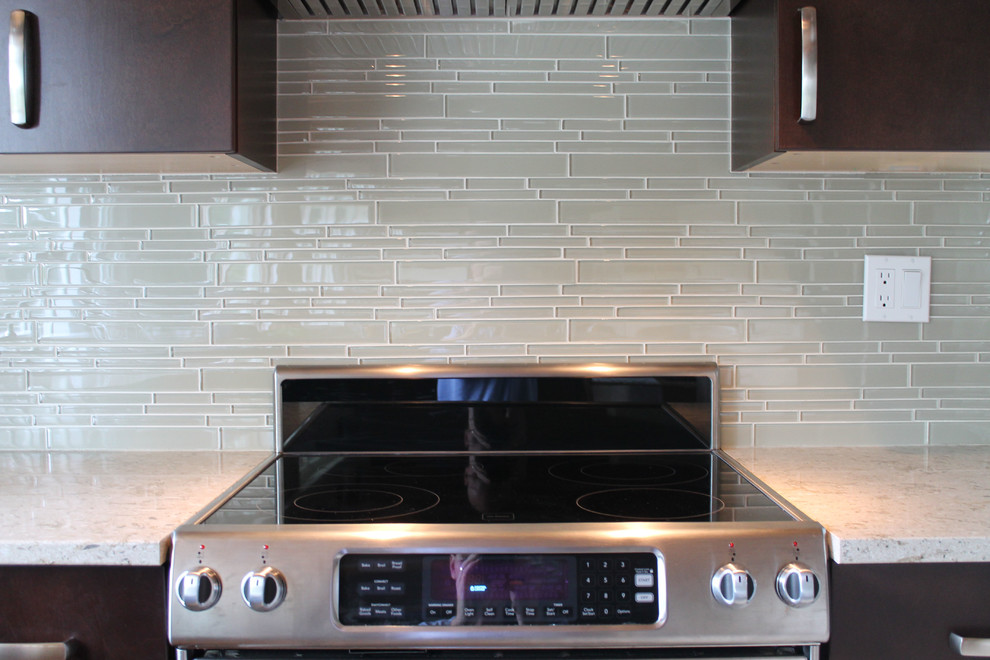 Photo of a contemporary kitchen in Vancouver with beige splashback and glass tile splashback.