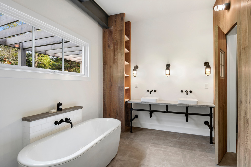 This is an example of a country master bathroom in New York with open cabinets, a freestanding tub, white tile, subway tile, white walls, a vessel sink, grey floor and grey benchtops.