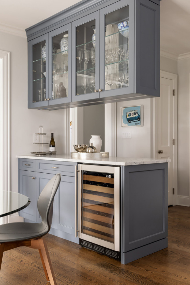 Inspiration for a mid-sized transitional single-wall bar cart in New York with shaker cabinets, blue cabinets, granite benchtops and medium hardwood floors.