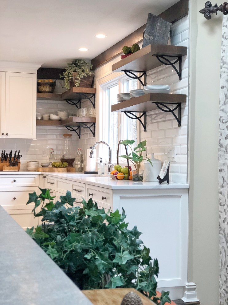 Example of a huge transitional dark wood floor and brown floor eat-in kitchen design with an undermount sink, shaker cabinets, white cabinets, quartz countertops, white backsplash, porcelain backsplash, stainless steel appliances, an island and white countertops