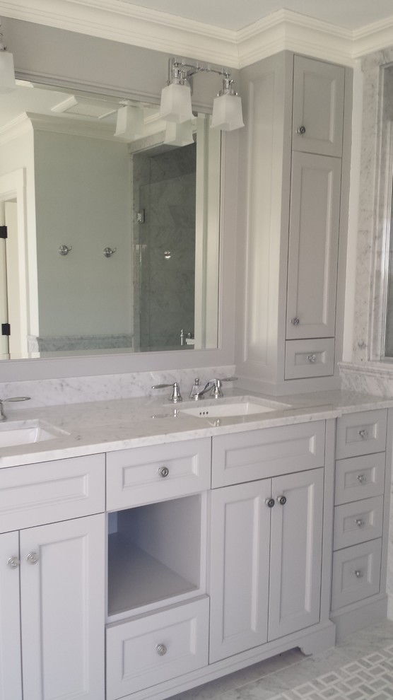 This is an example of a large traditional master bathroom in Boston with shaker cabinets, grey cabinets, a freestanding tub, a curbless shower, gray tile, porcelain tile, white walls, an integrated sink and marble benchtops.