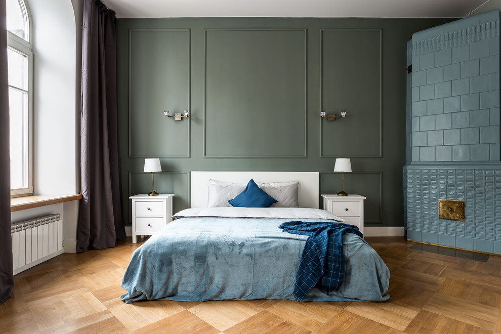 Inspiration for a transitional bedroom in Moscow with green walls, medium hardwood floors, a corner fireplace and brown floor.