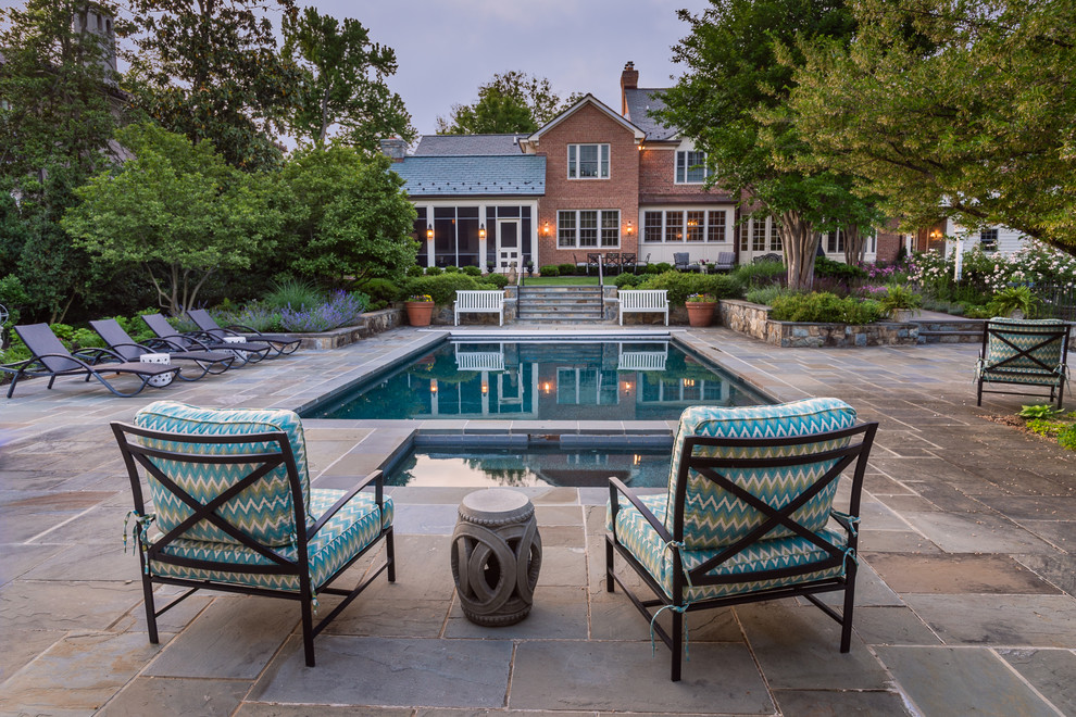Inspiration for a large transitional backyard rectangular lap pool in DC Metro with natural stone pavers.