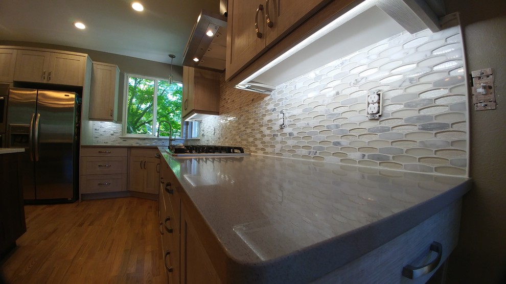 Example of a kitchen design in Seattle with quartz countertops and mosaic tile backsplash