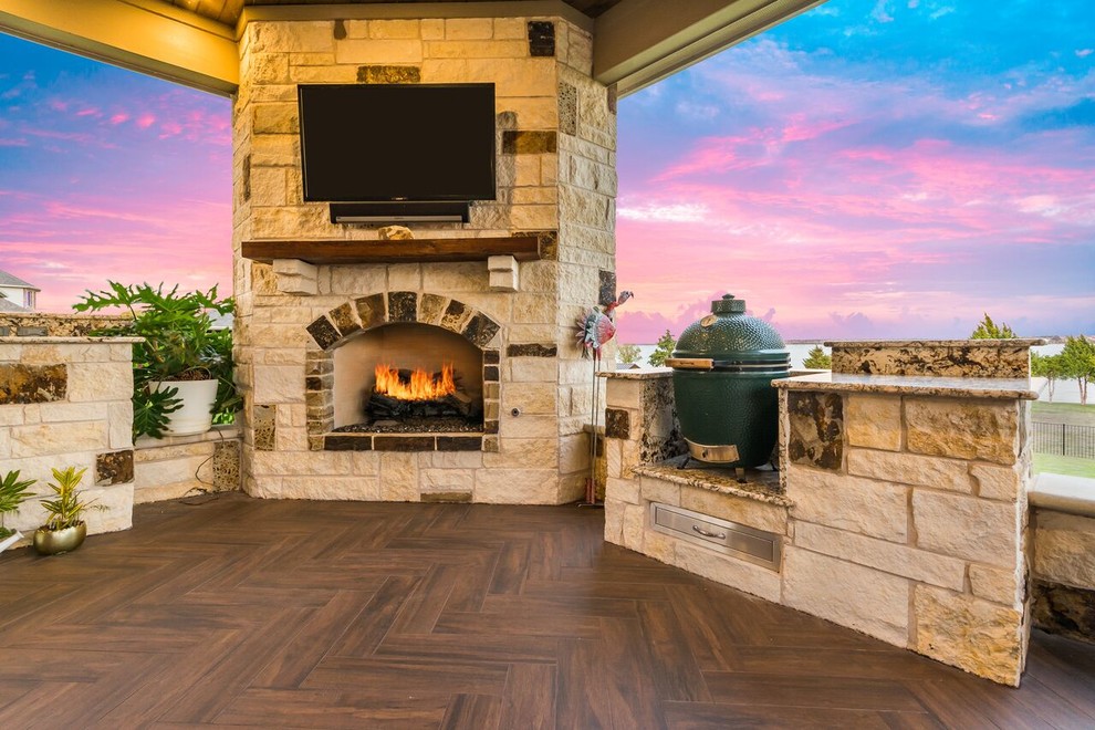 Photo of a mid-sized traditional backyard patio in Houston with a fire feature, tile and a roof extension.