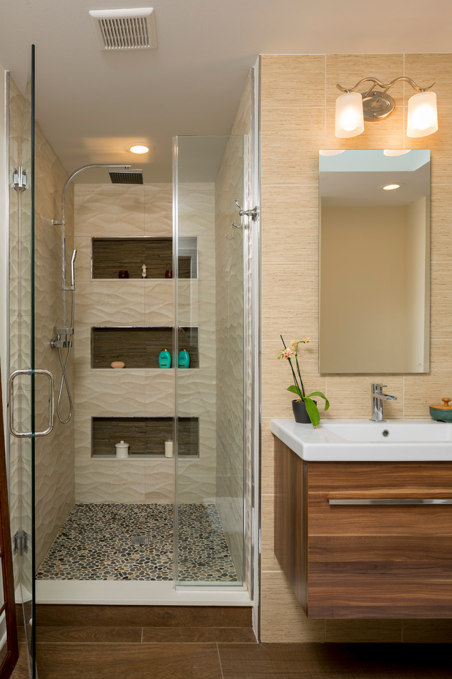 This is an example of a transitional bathroom in New York with flat-panel cabinets, light wood cabinets, a freestanding tub, an alcove shower, beige walls, an integrated sink and dark hardwood floors.