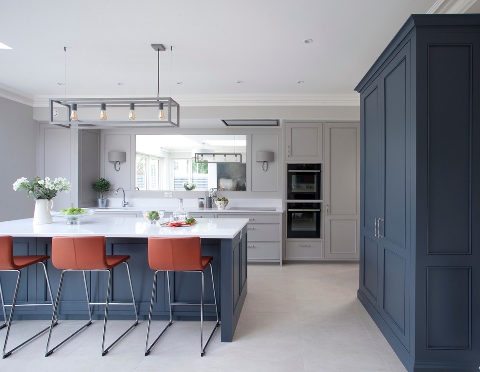 This is an example of a large contemporary kitchen in Dublin with beaded inset cabinets, quartzite benchtops, with island and white benchtop.