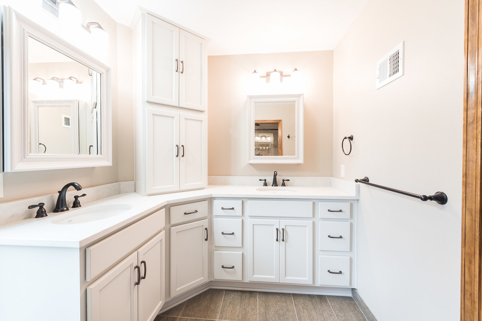 Inspiration for a mid-sized transitional master bathroom in Kansas City with shaker cabinets, white cabinets, an alcove shower, a one-piece toilet, white tile, ceramic tile, beige walls, ceramic floors, an undermount sink and marble benchtops.