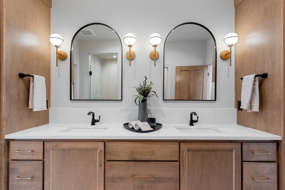 Inspiration for a large transitional master white tile double-sink toilet room remodel with shaker cabinets, brown cabinets, white walls, an undermount sink, quartz countertops, white countertops and a built-in vanity