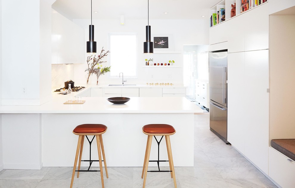 Kitchen - mid-sized modern u-shaped marble floor and gray floor kitchen idea in Toronto with flat-panel cabinets, white cabinets, solid surface countertops, stainless steel appliances, a double-bowl sink, white backsplash, marble backsplash and a peninsula