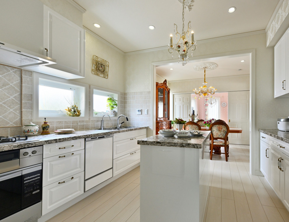 Photo of a medium sized traditional galley kitchen/diner in Other with a submerged sink, raised-panel cabinets, white cabinets, engineered stone countertops, beige splashback, marble splashback, white appliances, plywood flooring, an island, white floors, grey worktops and a wallpapered ceiling.