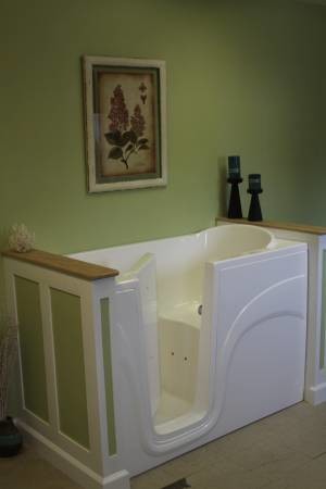 This is an example of a mid-sized arts and crafts 3/4 bathroom in Other with open cabinets, white cabinets, a hot tub, a two-piece toilet, white tile, ceramic tile, green walls, ceramic floors, an undermount sink and tile benchtops.