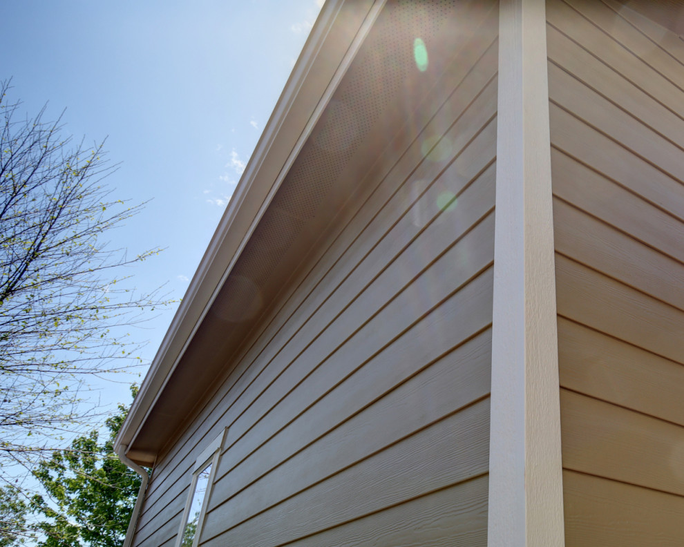 Photo of a mid-sized transitional two-storey beige house exterior in Denver with concrete fiberboard siding, a gable roof, a shingle roof, a black roof and clapboard siding.