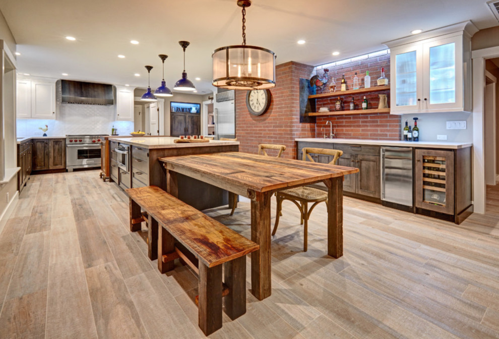This is an example of a large eclectic u-shaped eat-in kitchen in Dallas with an undermount sink, beaded inset cabinets, distressed cabinets, quartz benchtops, white splashback, ceramic splashback, stainless steel appliances, painted wood floors and with island.