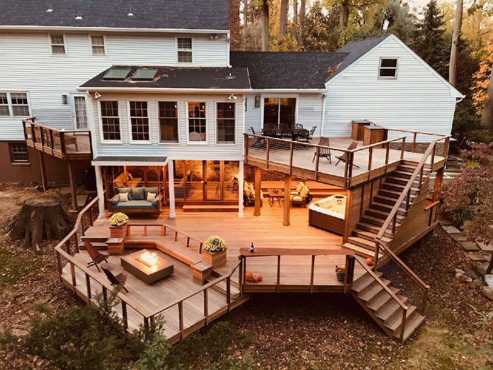 Inspiration for an expansive transitional backyard and ground level deck in Other with an outdoor shower, no cover and cable railing.
