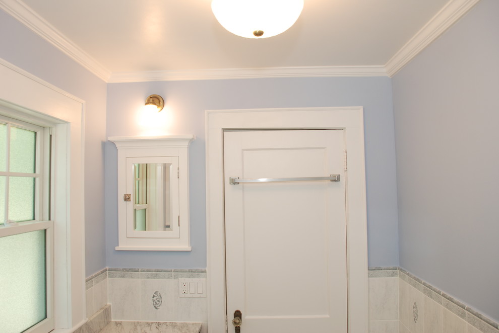 Design ideas for a mid-sized traditional bathroom in Newark with an undermount sink, dark wood cabinets, marble benchtops, white tile, ceramic tile, blue walls and linoleum floors.