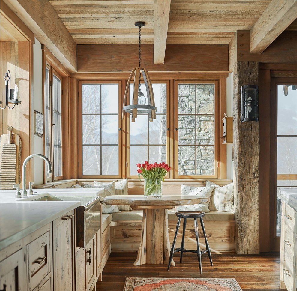 Photo of a country eat-in kitchen in Burlington with a farmhouse sink, shaker cabinets, light wood cabinets, medium hardwood floors, brown floor and white benchtop.
