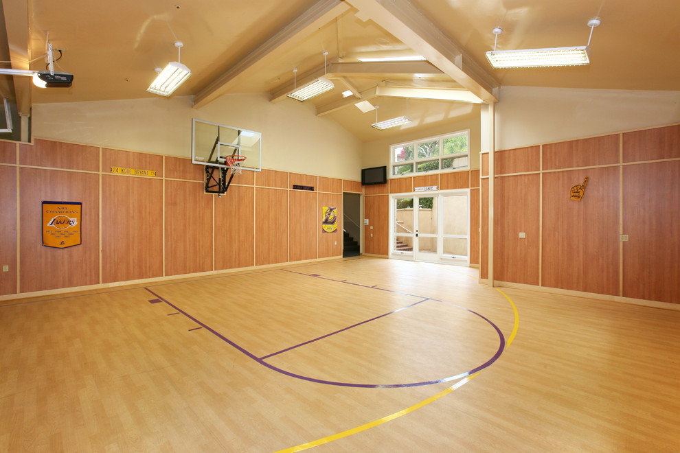 Design ideas for an expansive contemporary indoor sport court in Orange County with beige walls and light hardwood floors.