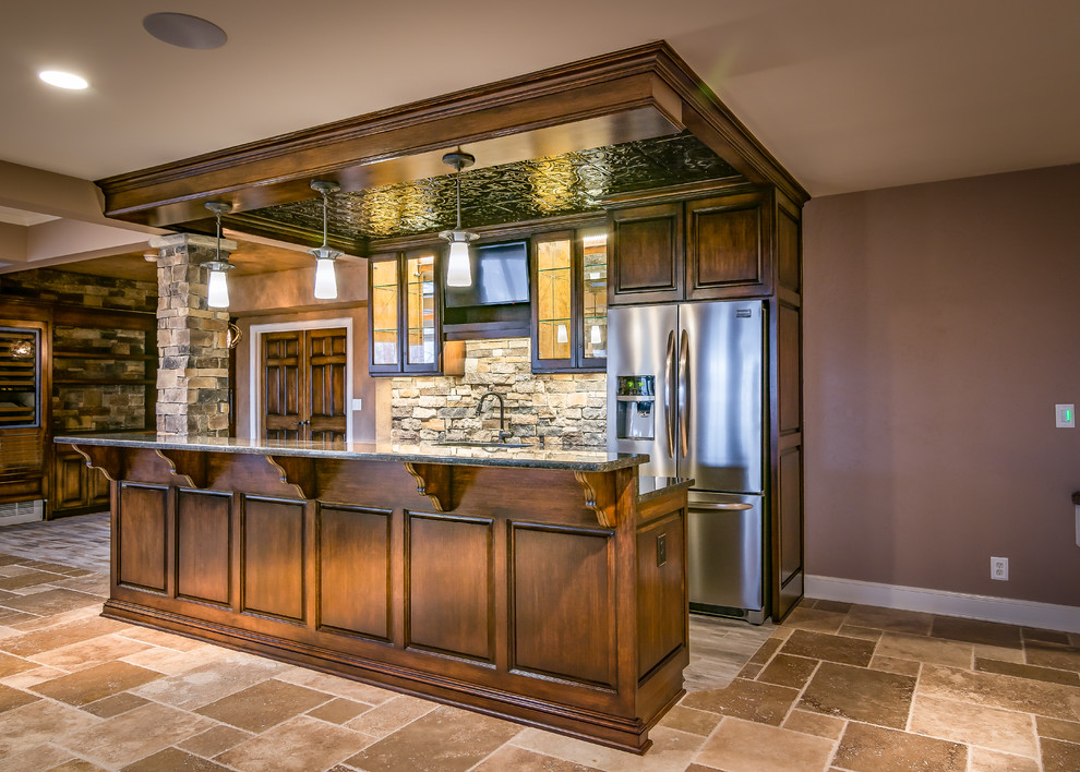Photo of a large country galley wet bar in Kansas City with an undermount sink, raised-panel cabinets, dark wood cabinets, granite benchtops, multi-coloured splashback, stone tile splashback and ceramic floors.