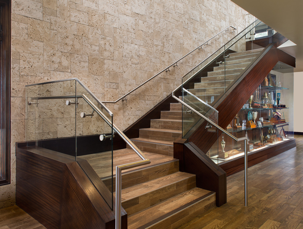 Photo of a large contemporary tile floating staircase in San Diego with tile risers.