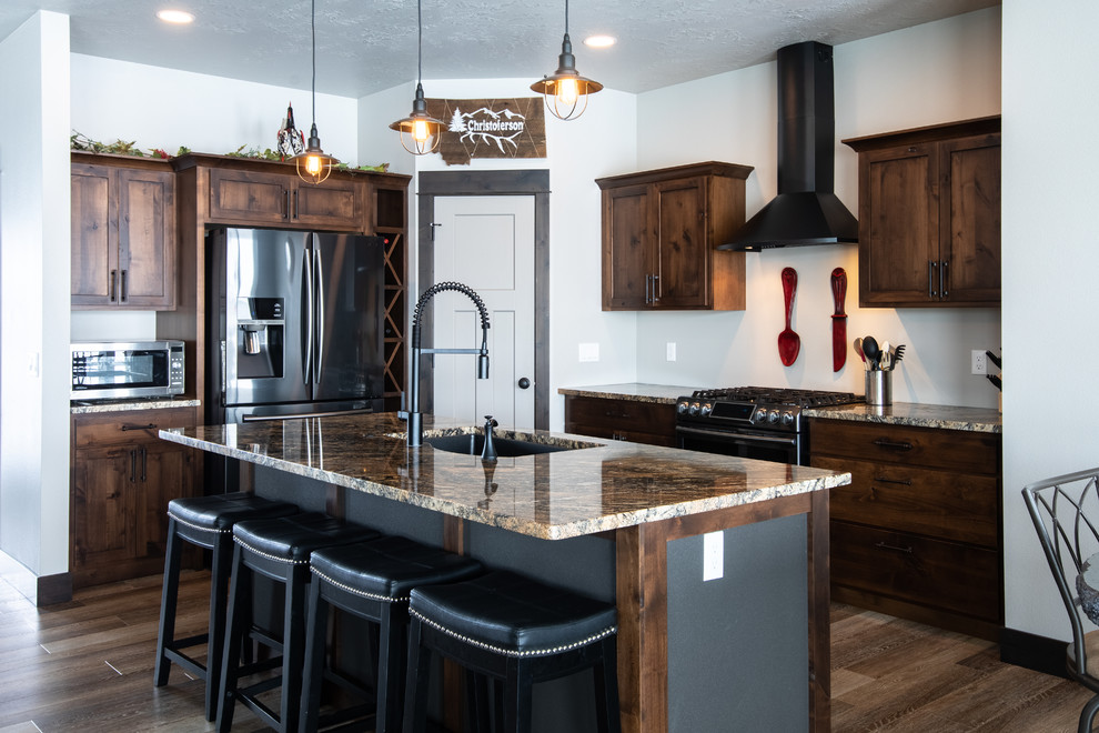 Eat-in kitchen - mid-sized transitional l-shaped medium tone wood floor and brown floor eat-in kitchen idea with an undermount sink, shaker cabinets, medium tone wood cabinets, granite countertops, stainless steel appliances, an island and beige countertops