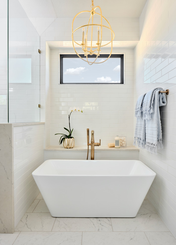 Inspiration for a mid-sized transitional master bathroom in Austin with furniture-like cabinets, blue cabinets, a freestanding tub, an open shower, a bidet, white tile, subway tile, white walls, marble floors, an undermount sink, engineered quartz benchtops, multi-coloured floor, a hinged shower door, white benchtops, an enclosed toilet, a double vanity and a built-in vanity.