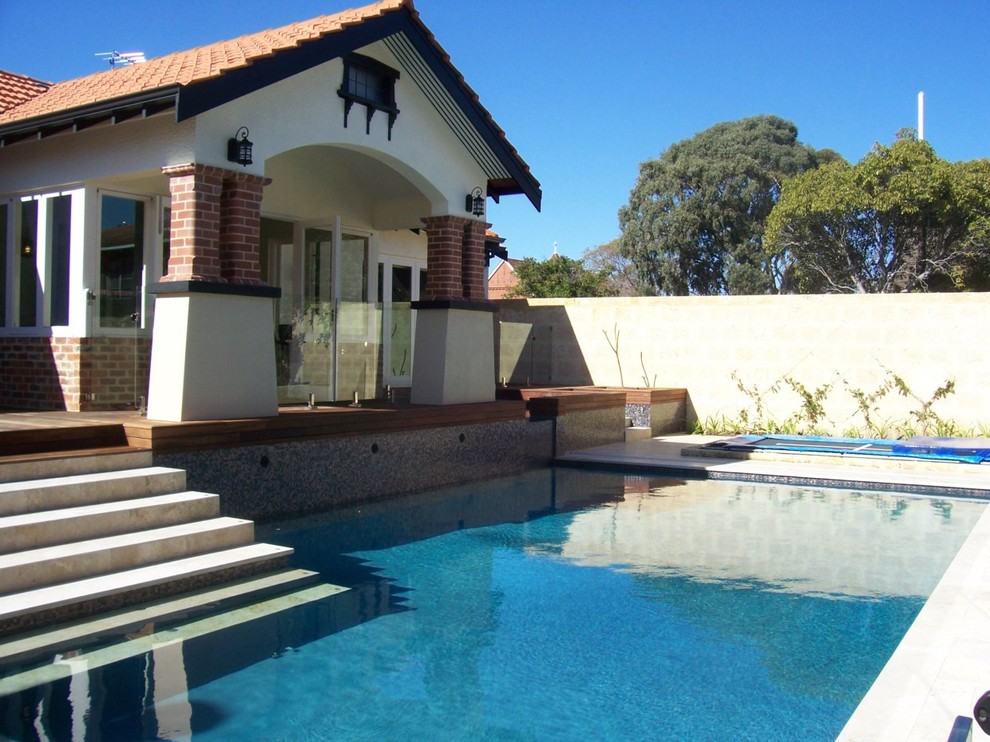 Photo of a large modern front yard custom-shaped natural pool in Perth with brick pavers.