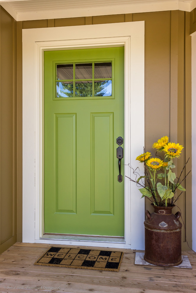 Photo of a beach style front door in Minneapolis with beige walls, a single front door and a green front door.