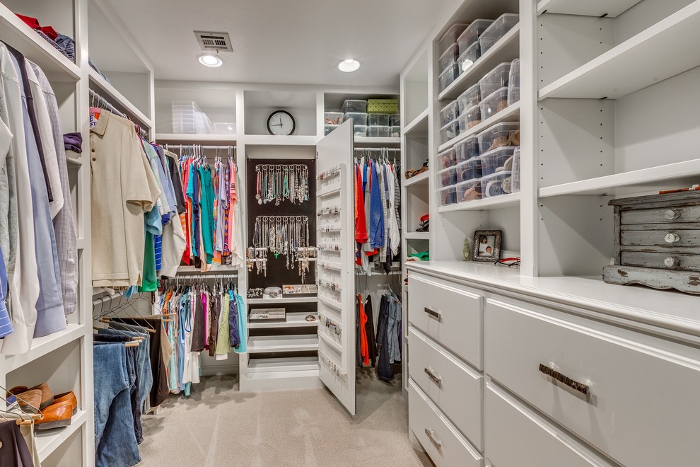 Inspiration for a large transitional gender-neutral walk-in wardrobe in Oklahoma City with open cabinets, white cabinets and carpet.