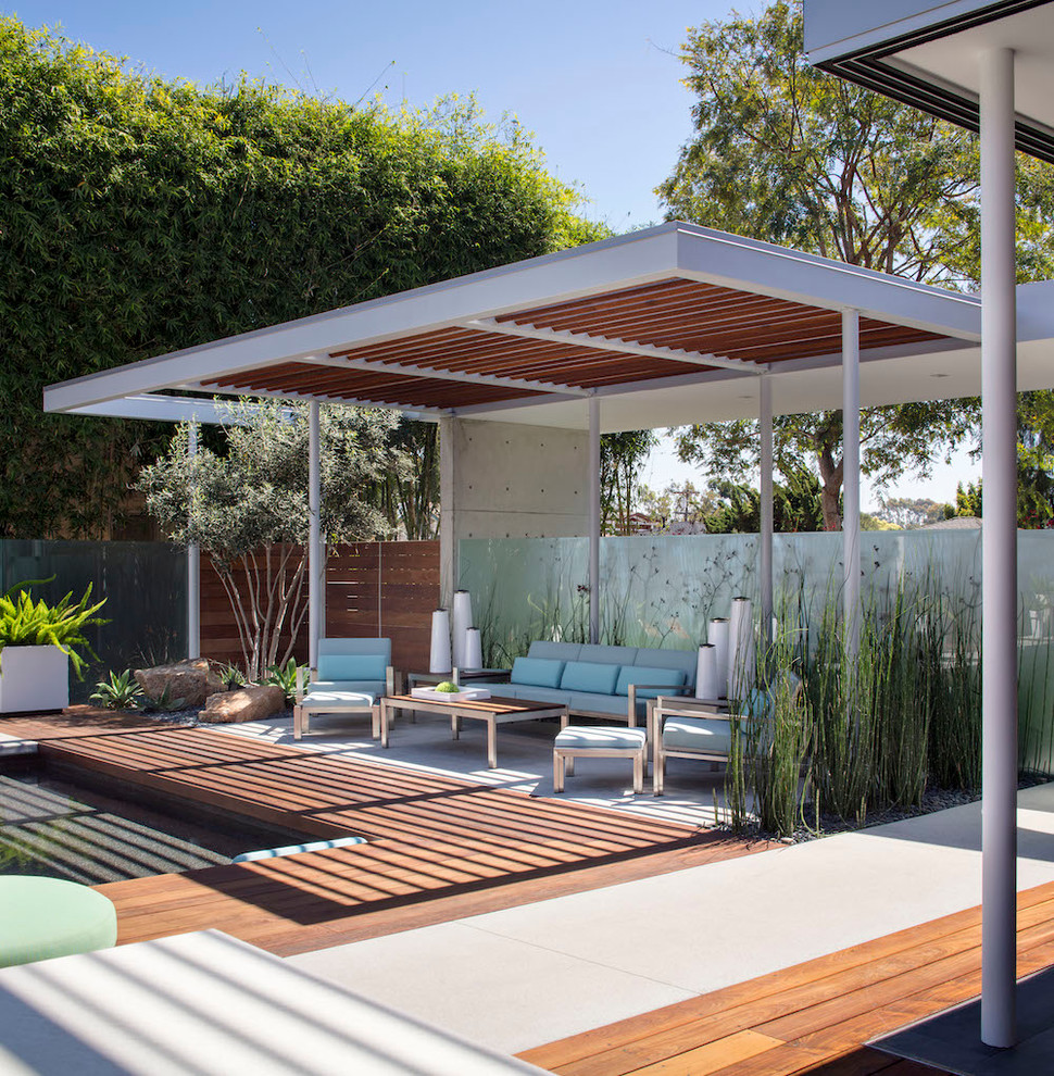 Inspiration for a large modern backyard patio in San Diego with a fire feature, decking and a gazebo/cabana.