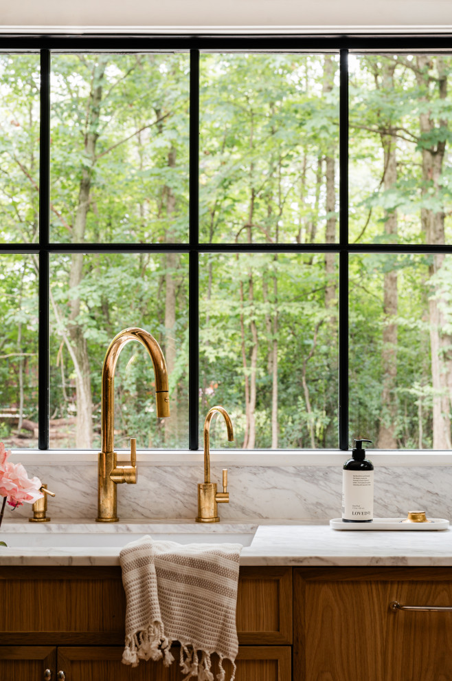 Mid-sized transitional l-shaped light wood floor eat-in kitchen photo in Chicago with an undermount sink, shaker cabinets, light wood cabinets, marble countertops, white backsplash, marble backsplash, paneled appliances, an island and white countertops