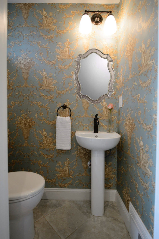 Design ideas for a small traditional powder room in Boston with green walls, porcelain floors and a pedestal sink.