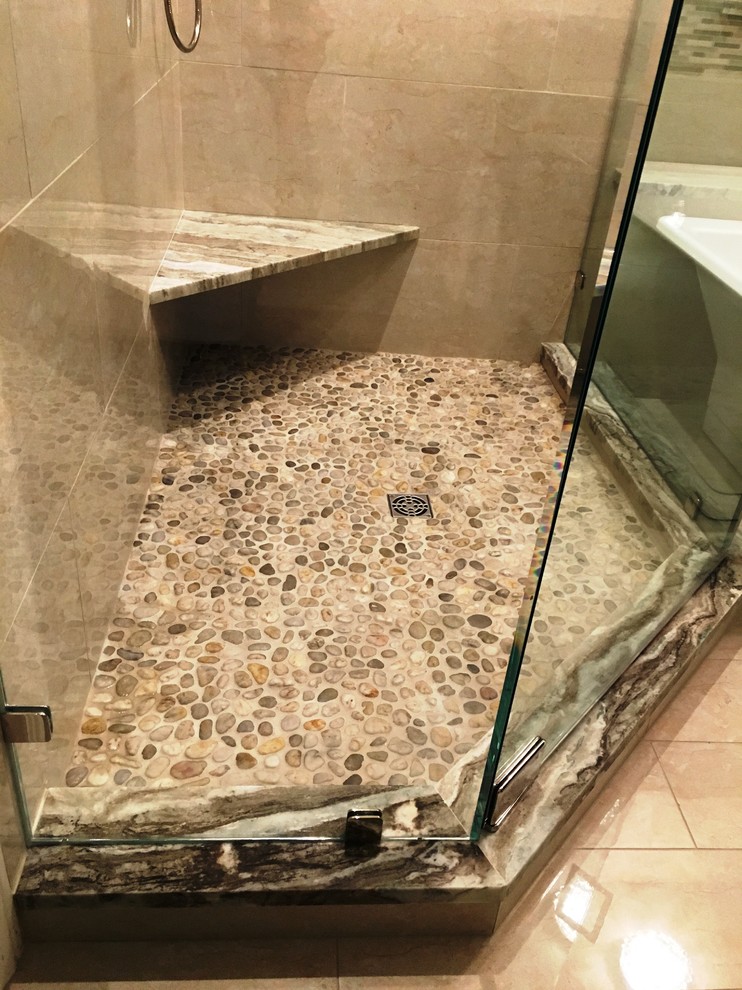 Large contemporary master bathroom in Austin with a corner shower, beige tile and porcelain tile.