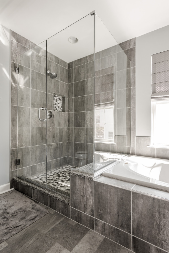 Large transitional master bathroom in Baltimore with white cabinets, a drop-in tub, a corner shower, gray tile, granite benchtops, grey floor, multi-coloured benchtops, a double vanity and a built-in vanity.