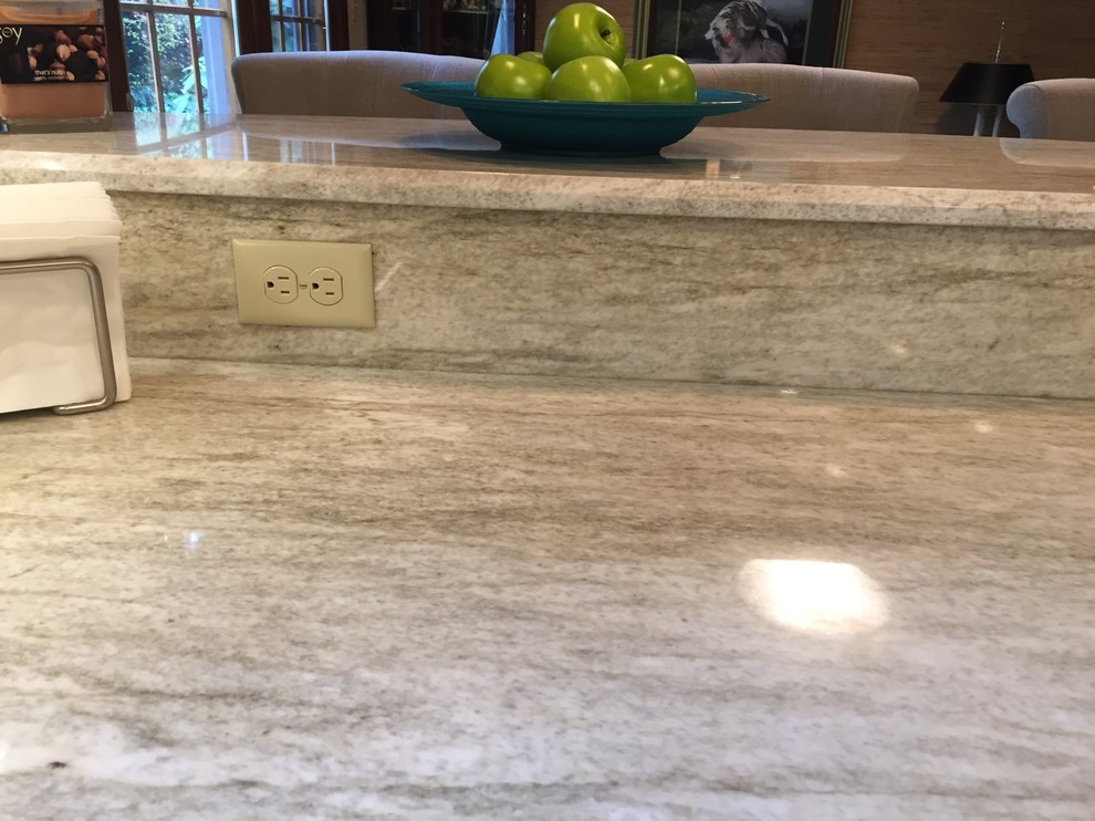 Example of a transitional ceramic tile kitchen design with a single-bowl sink, dark wood cabinets, multicolored backsplash, mosaic tile backsplash, stainless steel appliances and an island
