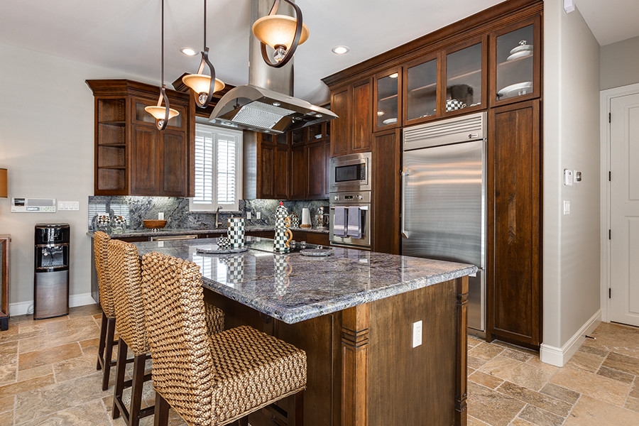 Mid-sized transitional travertine floor eat-in kitchen photo in Austin with an undermount sink, granite countertops, stainless steel appliances and an island