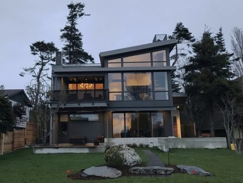 Design ideas for a contemporary two-storey house exterior in Seattle with a metal roof.