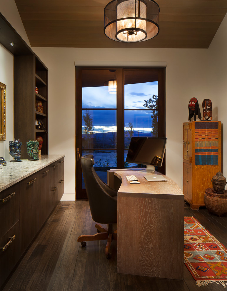 This is an example of a mid-sized transitional study room in Denver with beige walls, dark hardwood floors, a freestanding desk, no fireplace and brown floor.