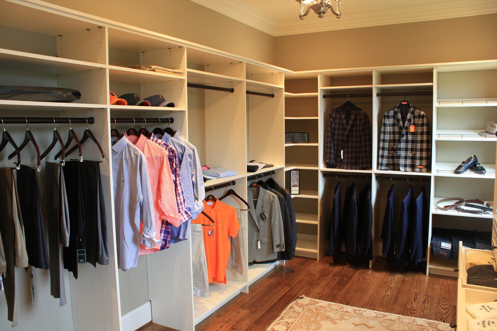This is an example of a traditional men's walk-in wardrobe in Nashville with open cabinets, white cabinets and dark hardwood floors.