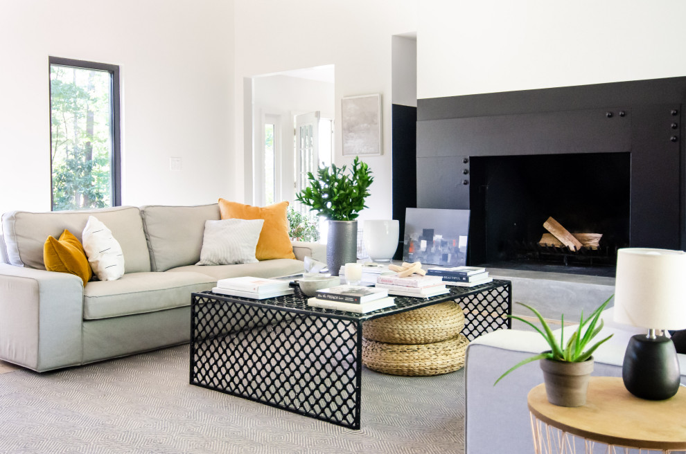 Inspiration for a contemporary open concept living room in Atlanta with white walls and a standard fireplace.