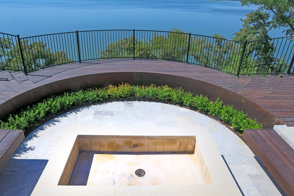 Example of a large minimalist backyard ground level deck design