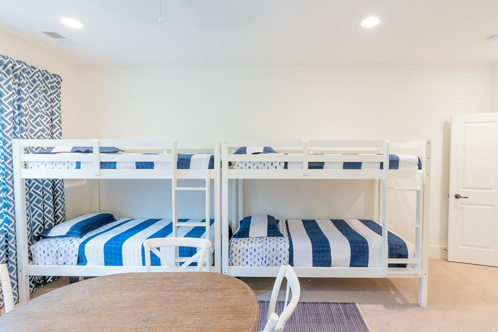 This is an example of a mid-sized beach style kids' room for kids 4-10 years old in Atlanta with white walls, carpet and beige floor.