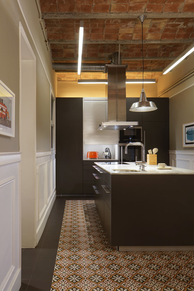 This is an example of a large industrial u-shaped separate kitchen in Other with a single-bowl sink, shaker cabinets, stainless steel appliances, ceramic floors, with island and multi-coloured floor.
