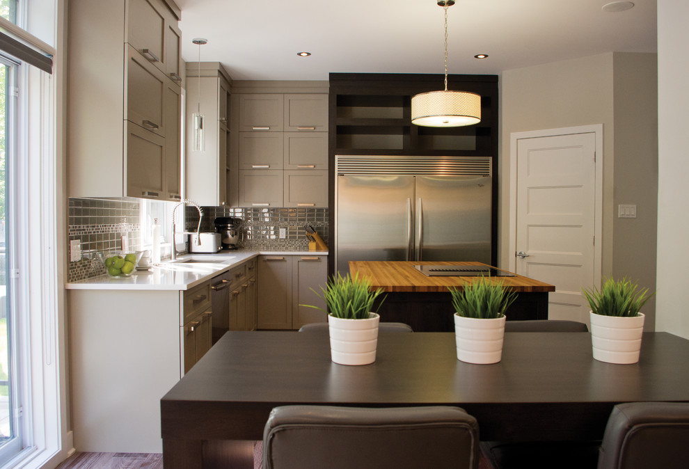Kitchen - transitional l-shaped kitchen idea in Montreal with gray cabinets, wood countertops and an island